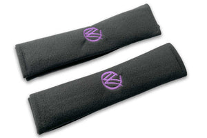 VW Graffiti logo embroidered seat belt covers shown in black with purple embroidery