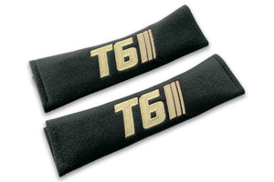 T6 Stripes single colour logo embroidered on padded seat belt covers shown in black with cream embroidery.