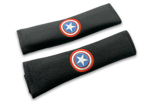 American Shield logo embroidered seat belt covers shown in black with red white and blue embroidery