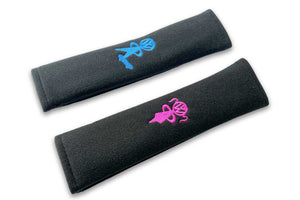VW Bobblehead Kids logo embroidered seat belt covers shown in black with a blue boy and pink girl embroidery