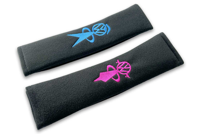 VW Bobblehead logo embroidered seat belt covers shown in black with blue man and pink woman embroidery