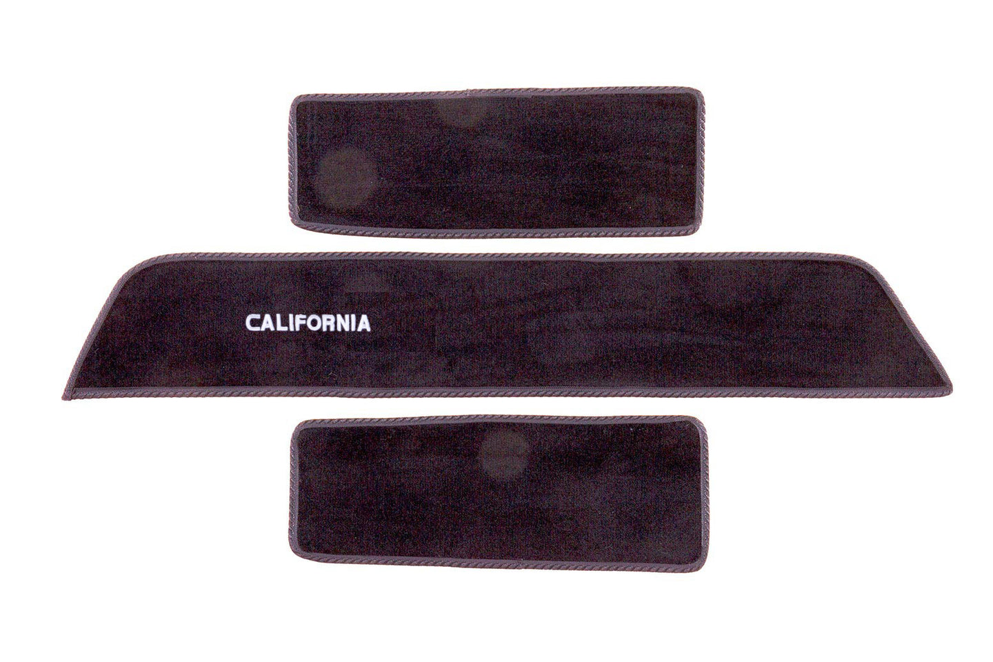 Transporter California side step mat set shown in black automotive carpet with white embroidered California logo