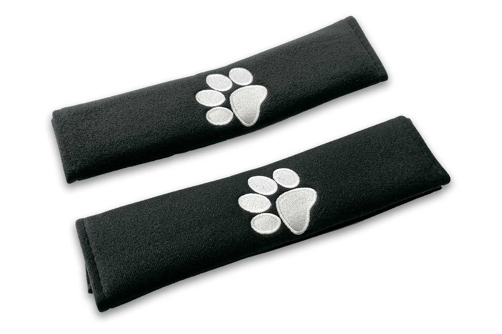 Paw print logo embroidered seat belt covers shown in black with white embroidery