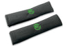 VW Graffiti logo embroidered seat belt covers shown in black with green embroidery