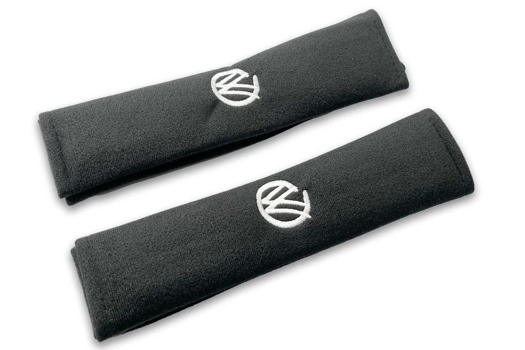 VW Graffiti logo embroidered seat belt covers shown in black with white embroidery