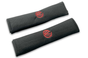 VW Graffiti logo embroidered seat belt covers shown in black with red embroidery