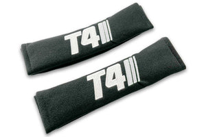 T4 Stripes single colour logo embroidered on padded seat belt covers shown in black with white embroidery.