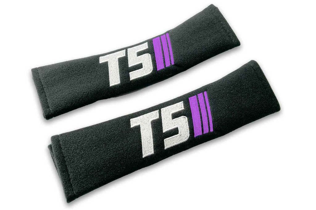 T5 Stripes logo embroidered on padded seat belt covers shown in black with white and purple embroidery.