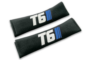 T6 Stripes logo embroidered on padded seat belt covers shown in black with white and blue embroidery.