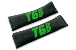 T6 Stripes single colour logo embroidered on padded seat belt covers shown in black with green embroidery.