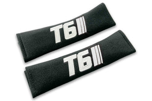 T6 Stripes single colour logo embroidered on padded seat belt covers shown in black with white embroidery.