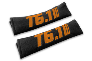 T6.1 Stripes single colour logo embroidered on padded seat belt covers shown in black with orange embroidery.