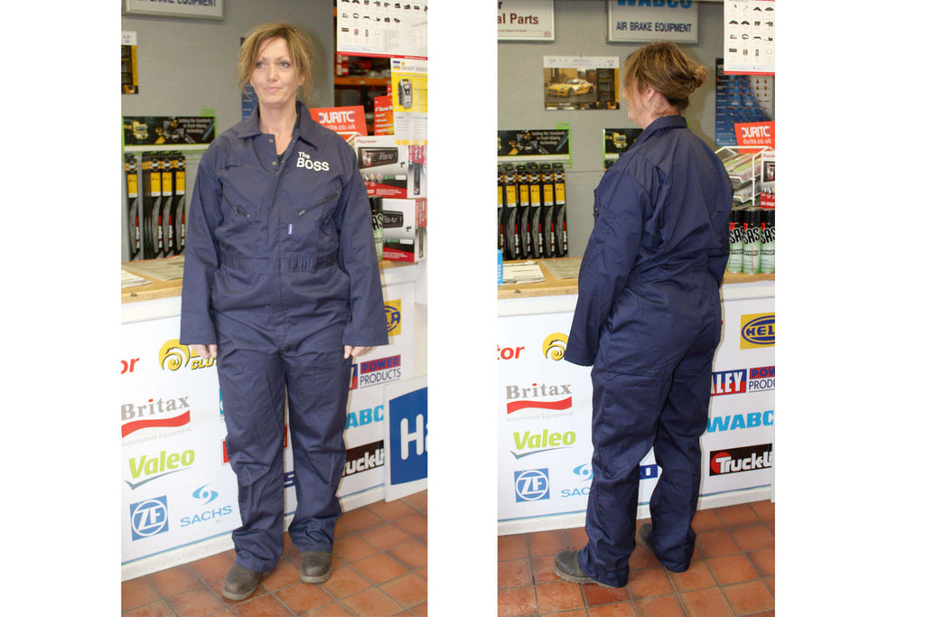 Dark blue cotton overalls shown on a female model with The Boss embroidered on the left chest pocket