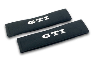 GTI embroidered seat belt covers shown in black with blue and white embroidery