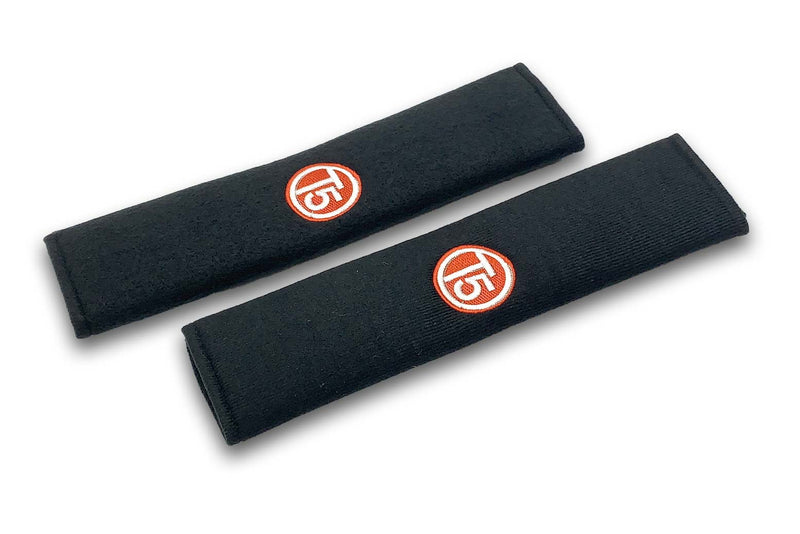 T5 Circle logo embroidered seat belt covers shown in black with red and white embroidery