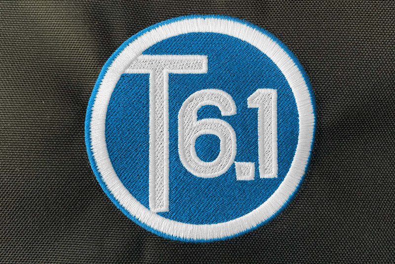 T6 point 1 embroidered circle logo with white text over a lime green background