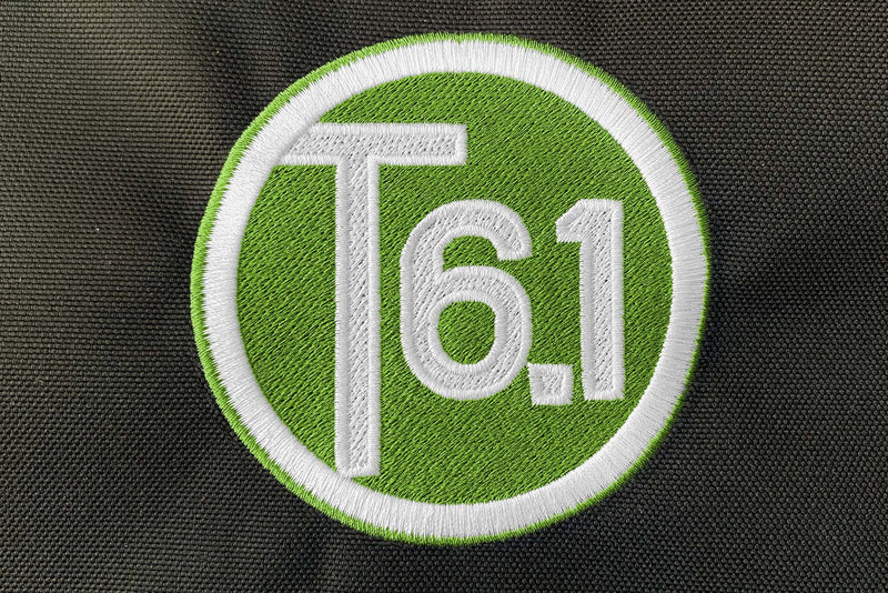 T6 point 1 embroidered circle logo with white text over a lime green background