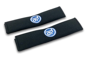 T6 Circle logo embroidered seat belt covers shown in black with blue and white embroidery
